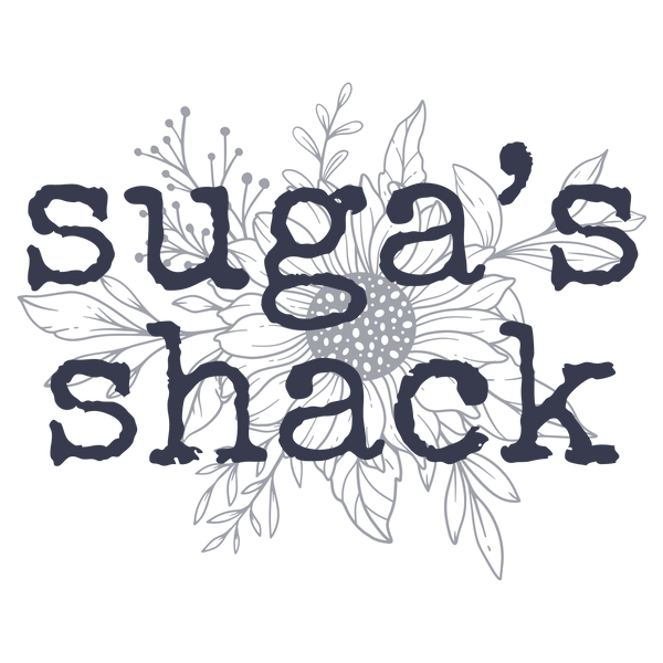 The text 'suga's shack' in a dark navy blue rustic font, overlaid on a light gray line art illustration of a sunflower and leaves, on a solid white background.